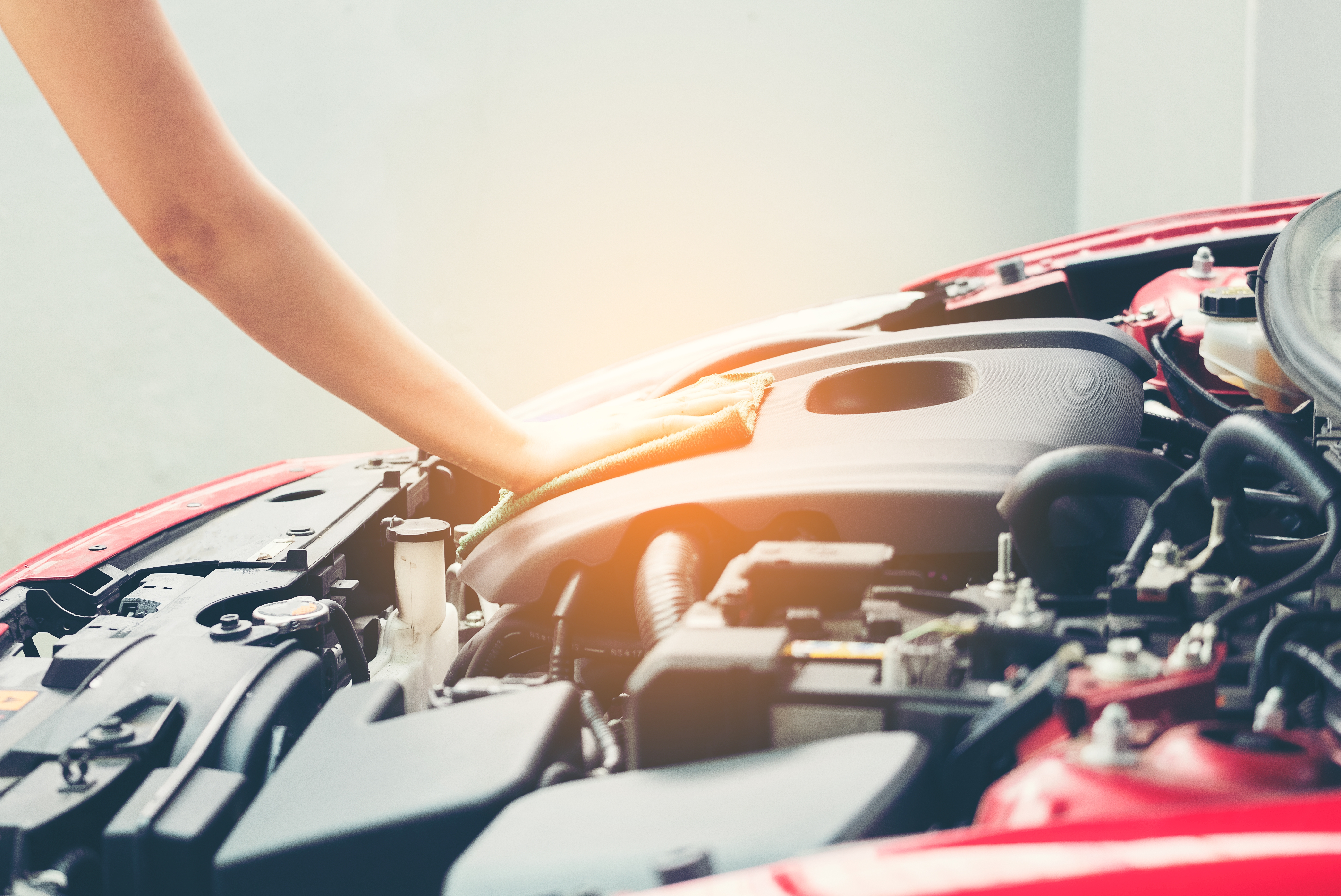 Woman wiping car engine for new vehicle, Car detailing series : Cleaning car engine